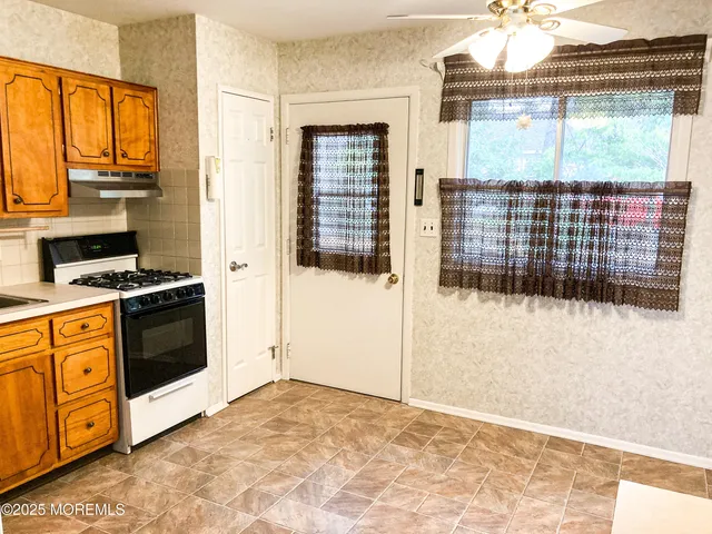 a view of a kitchen with a sink and cabinets