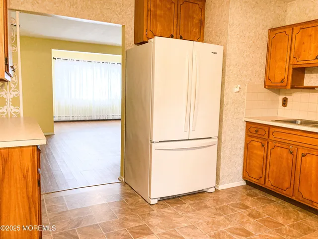a white refrigerator freezer sitting in a kitchen