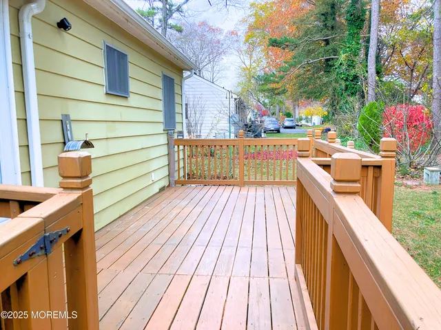 a view of balcony with wooden floor and outdoor seating