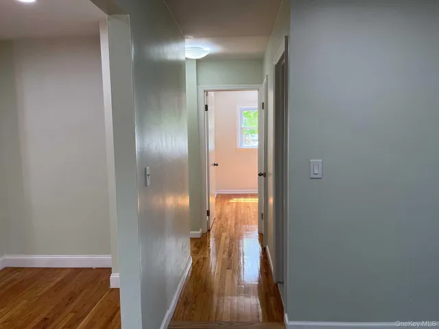 a view of hallway with wooden floor