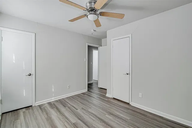 a view of an empty room and wooden floor