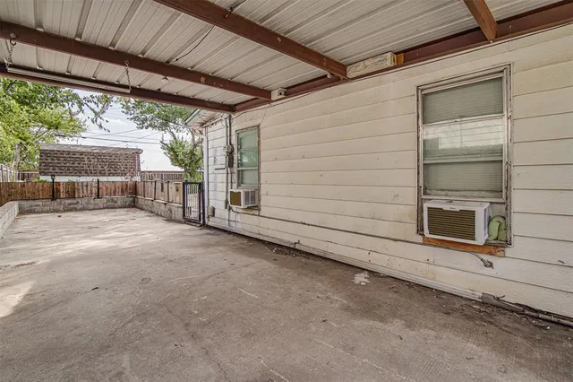 a view of a porch with furniture and floor to ceiling window