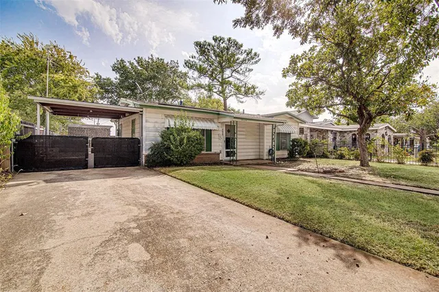 a front view of a house with a yard and a garage