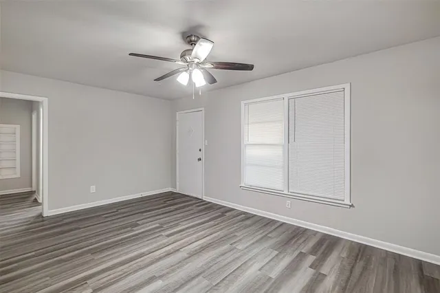 wooden floor in an empty room with a window