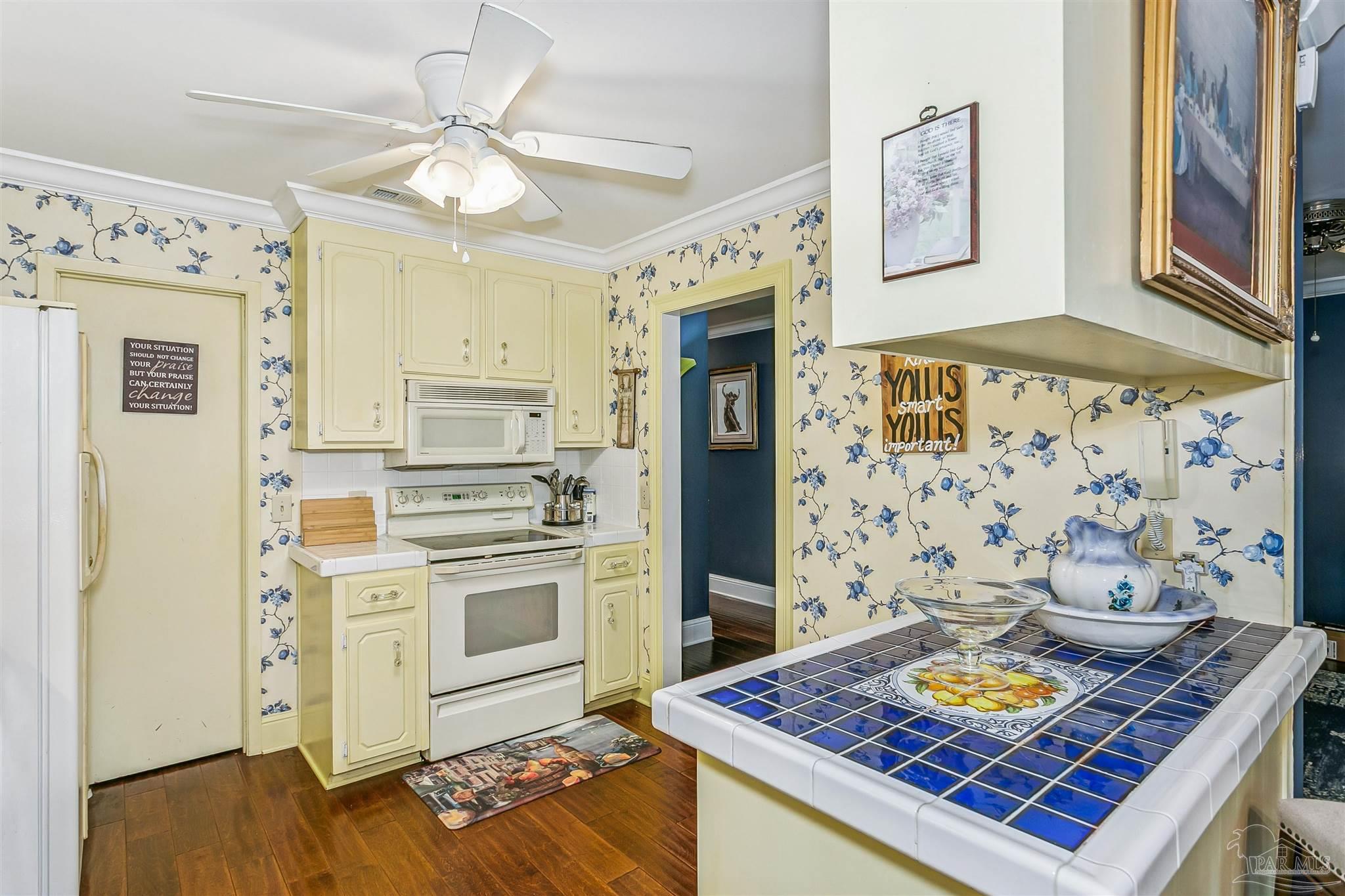 4831 East Olive Road, Unit 2D Pensacola, FL 32514 - Photo 16 of 29 a living room with stainless steel appliances kitchen island granite countertop furniture and a fireplace