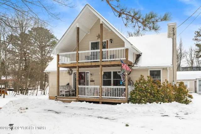 a view of a house with snow on the road