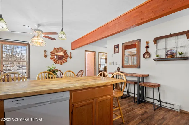 a view of a kitchen area with furniture and wooden floor