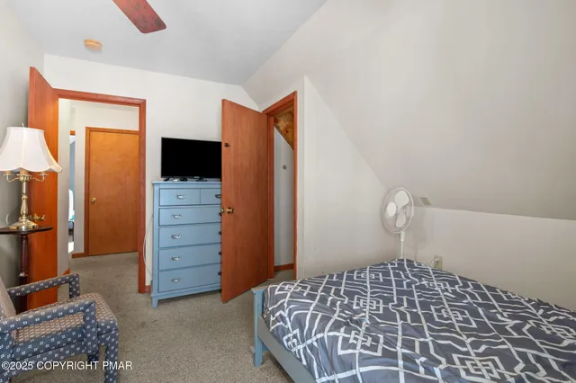 a bedroom with a bed and a television