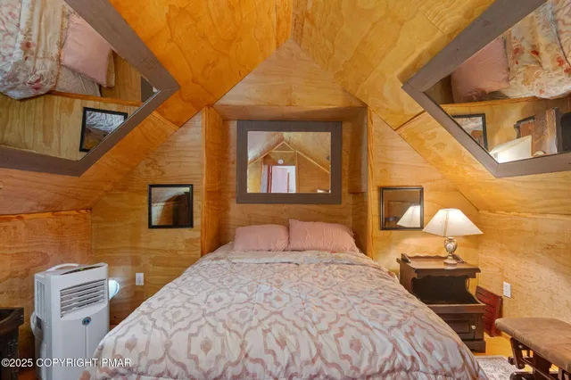 a bedroom with a bed and a painting on the wall