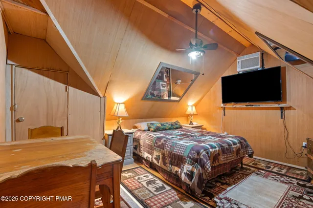 a bedroom with bed and tv