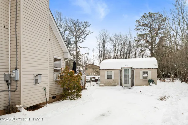 a view of a house with a snow in the yard