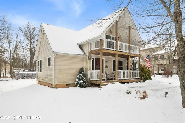 a view of a house with snow on the road
