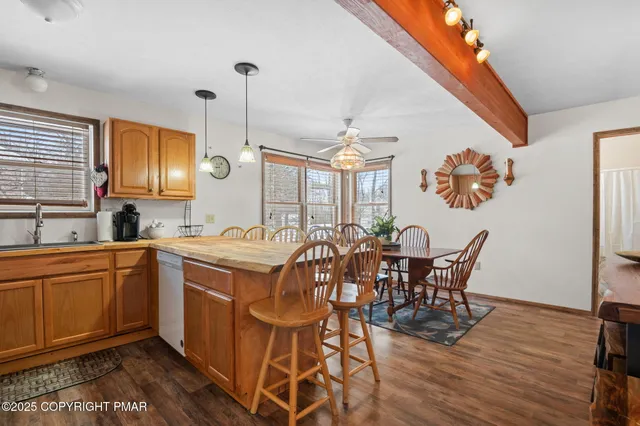 a kitchen with a dining table chairs and white cabinets