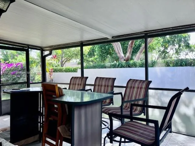 a dining room with furniture a chandelier and wooden floor