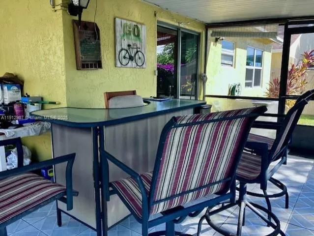 a view of hall way with furniture and paintings on the wall