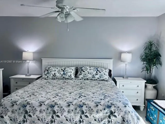 a bedroom with a bed and a lamp