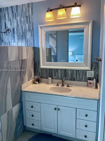a bathroom with a tub sink and mirror