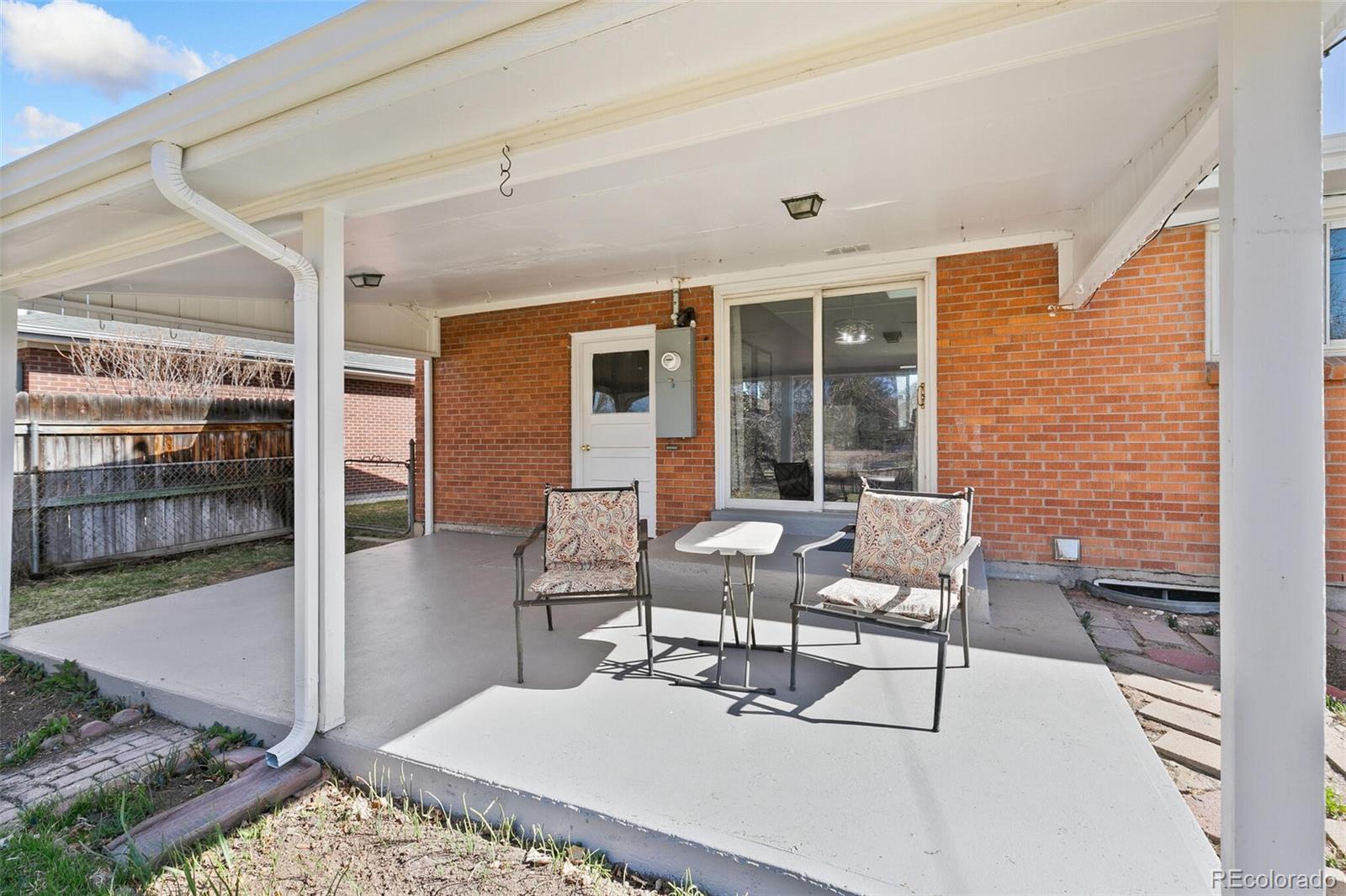 5500 Vale Drive Denver, CO 80246 - Photo 30 of 40 a balcony with chairs and glass door