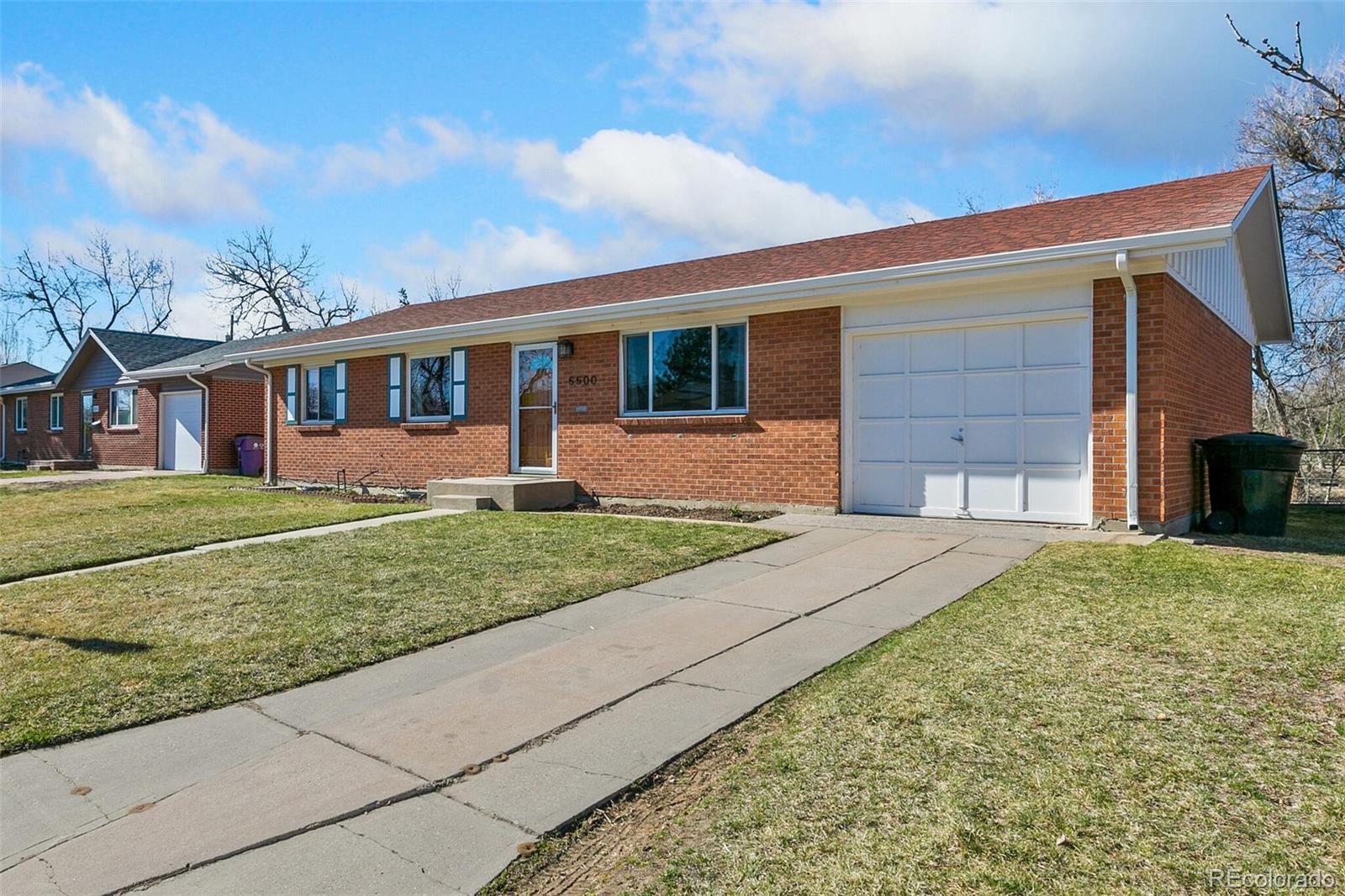 5500 Vale Drive Denver, CO 80246 - Photo 6 of 40 a front view of a house with a yard and garage