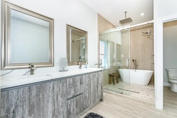 a view of a backyard with table and chairs potted plants and palm tree
