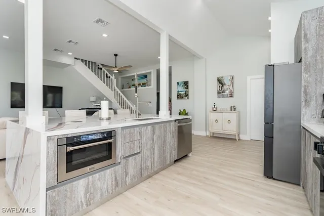 a kitchen with stainless steel appliances a refrigerator and a sink