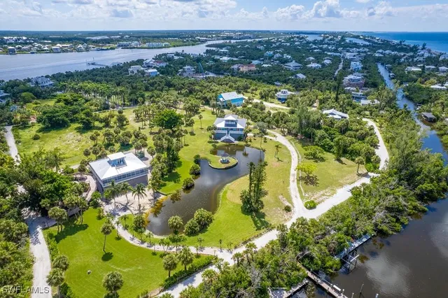 a view of a lake with a yard and trees