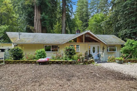 a view of an house with backyard space and garden
