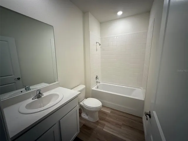 a view of a room with an empty space and a ceiling fan