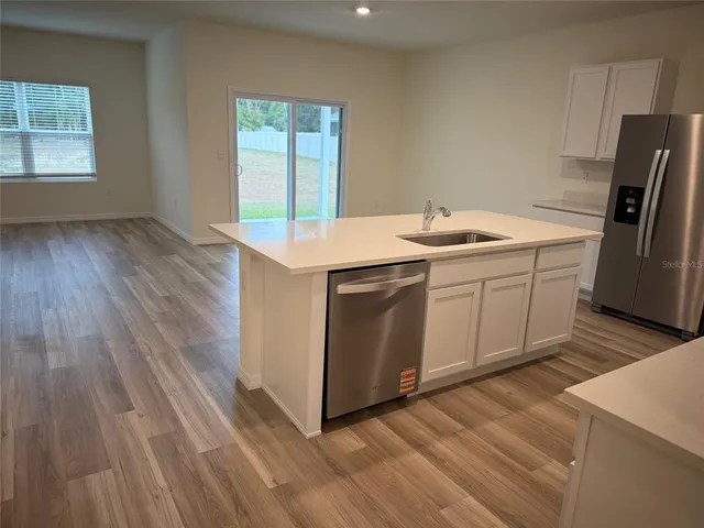 a utility room with a sink dryer and washer