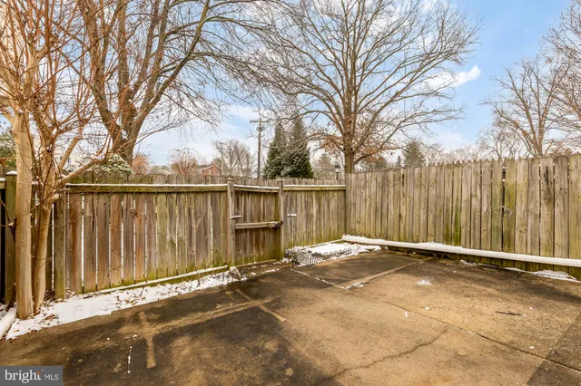 a backyard of a house with wooden fence