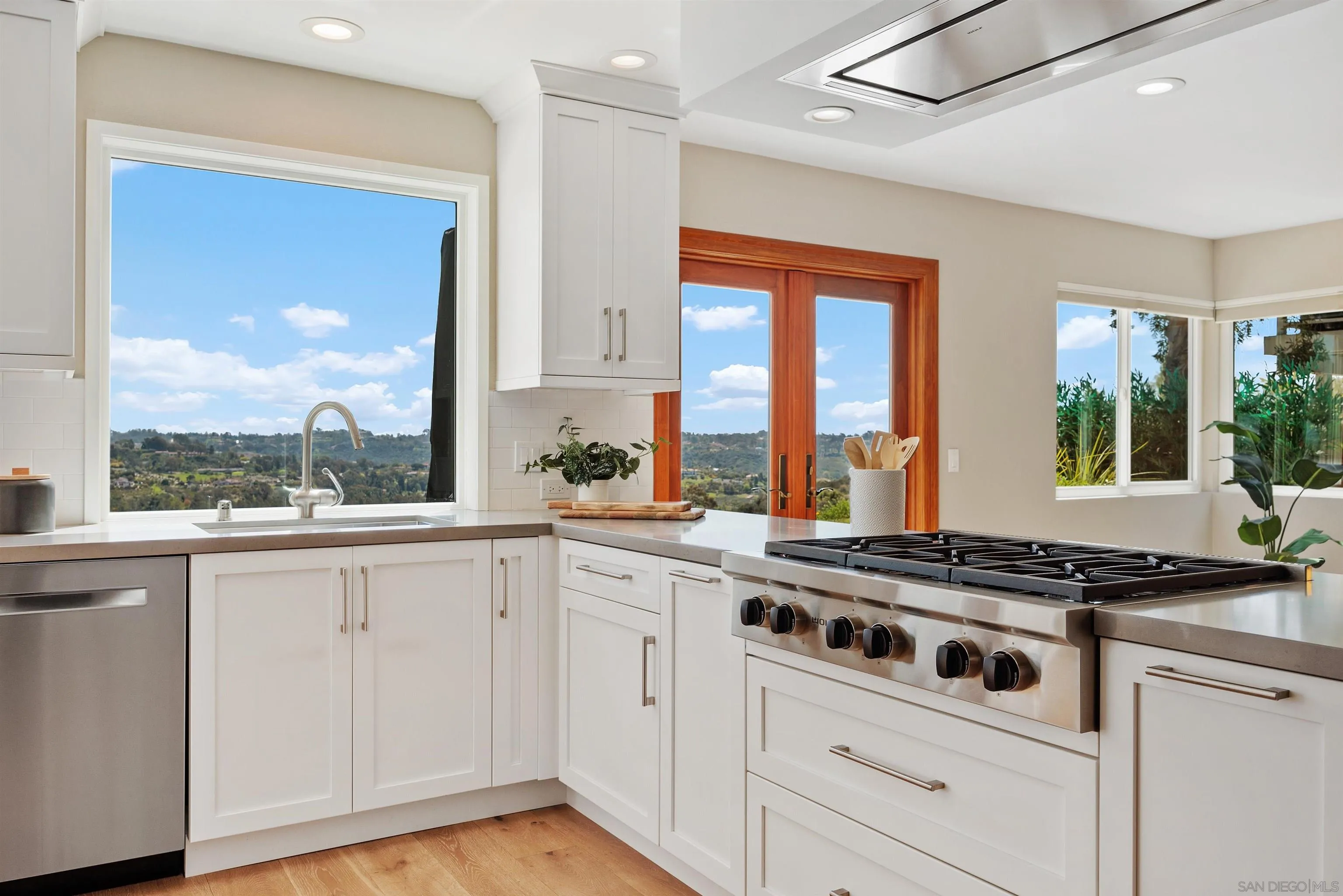 1533 Pacific Ranch Drive Encinitas, CA 92024 - Photo 15 of 52 a stove top oven sitting inside of a kitchen