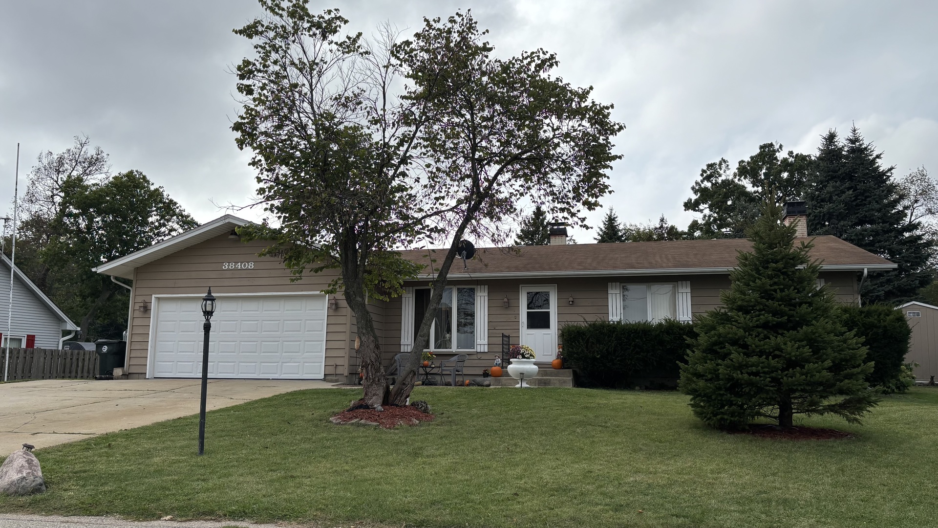 a front view of a house with a garden and yard