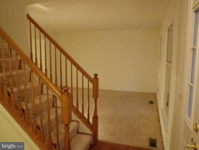 6511 Upland Road Fork, MD 21051 - Photo 13 of 23 a view of staircase with wooden floor and white walls