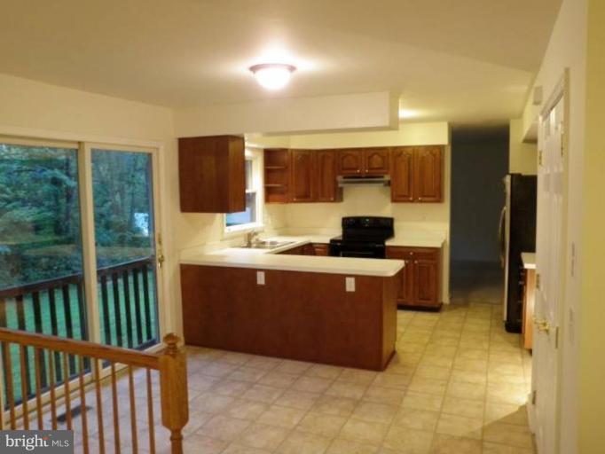 6511 Upland Road Fork, MD 21051 - Photo 8 of 23 a kitchen with stainless steel appliances granite countertop a stove a sink and a refrigerator