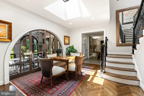 a living room with furniture a rug a fireplace and windows