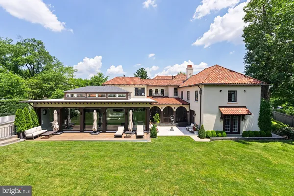 a front view of a house with a yard table and chairs