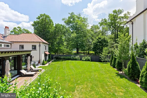 a view of a patio with table and chairs under an umbrella