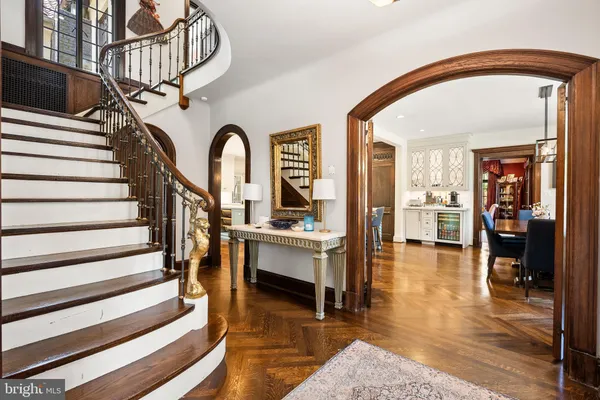 a view of entryway and hall with wooden floor