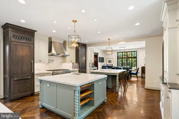 a kitchen with a stove a refrigerator and a dining table