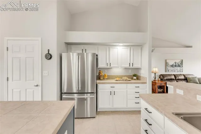 a kitchen with stainless steel appliances a refrigerator sink and cabinets