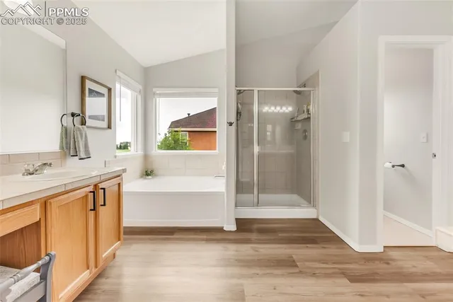 a bathroom with a tub shower and sink
