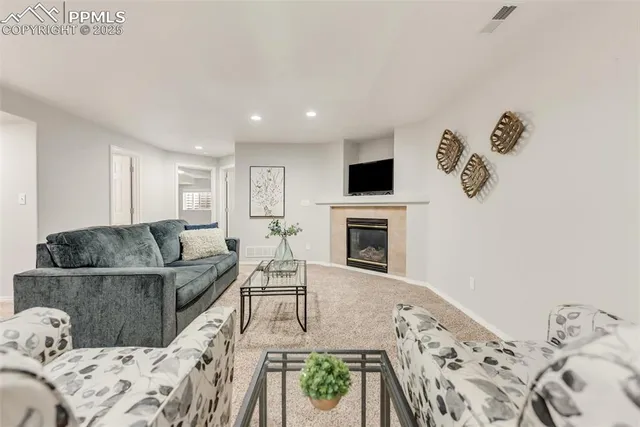 a living room with furniture and a fireplace