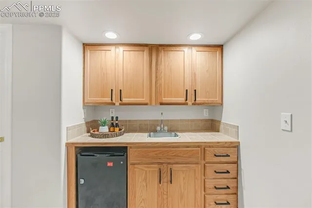 a kitchen with a sink cabinets and a window
