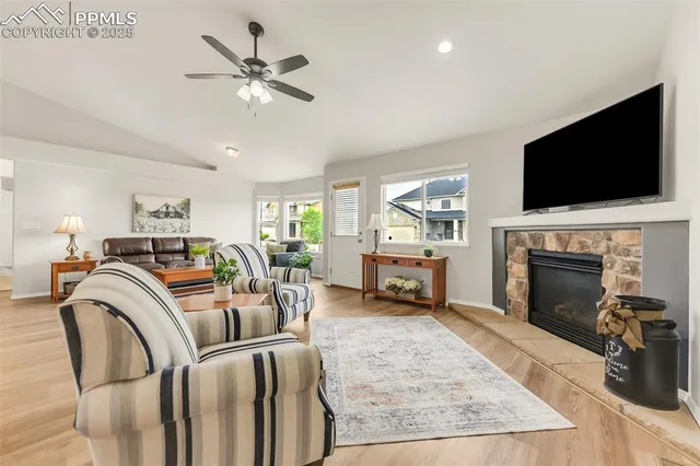 a living room with furniture a fireplace and a flat screen tv