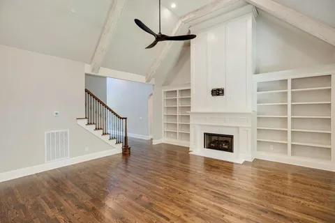 a kitchen with stainless steel appliances granite countertop a sink a stove and a wooden floors