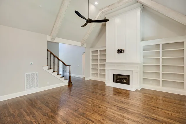 a kitchen with stainless steel appliances granite countertop a sink a stove and a wooden floors