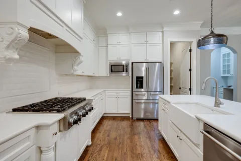 a view of a livingroom with wooden floor and a fireplace