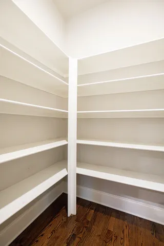 a view of walk in closet with empty racks