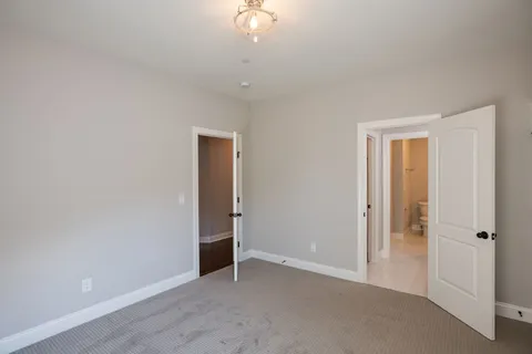 a spacious bathroom with a granite countertop sink mirror and a