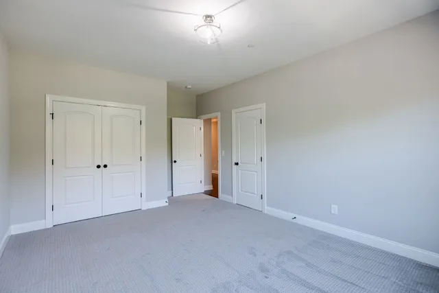 a view of a patio with couches table and chairs with wooden floor and fence